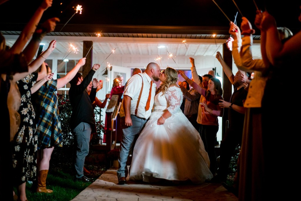 Bride and Groom kissing under sparklers at Meadowview Wedding Venue