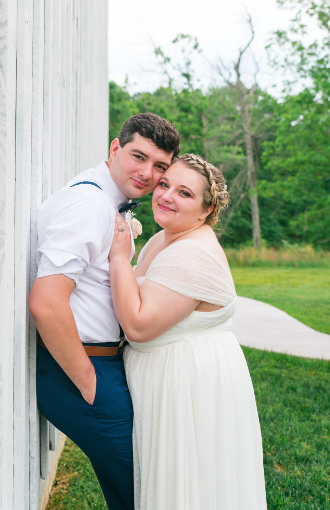 bride and groom standing against a wall at Meadowview wedding venue