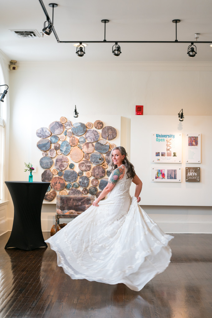 Bride spinning in dress in art gallery