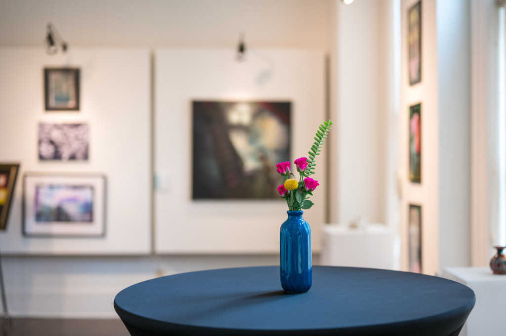 Flowers in blue vase in art gallery