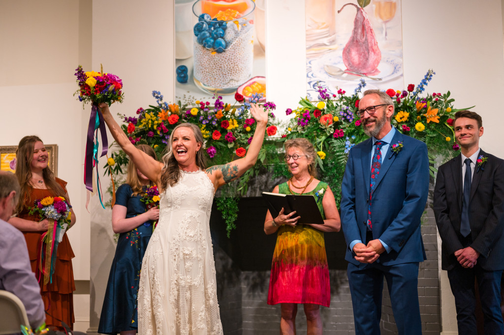 Bride with raised arms during ceremony