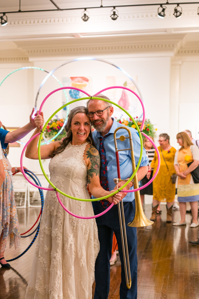 bride and groom with hula hoop and trombone